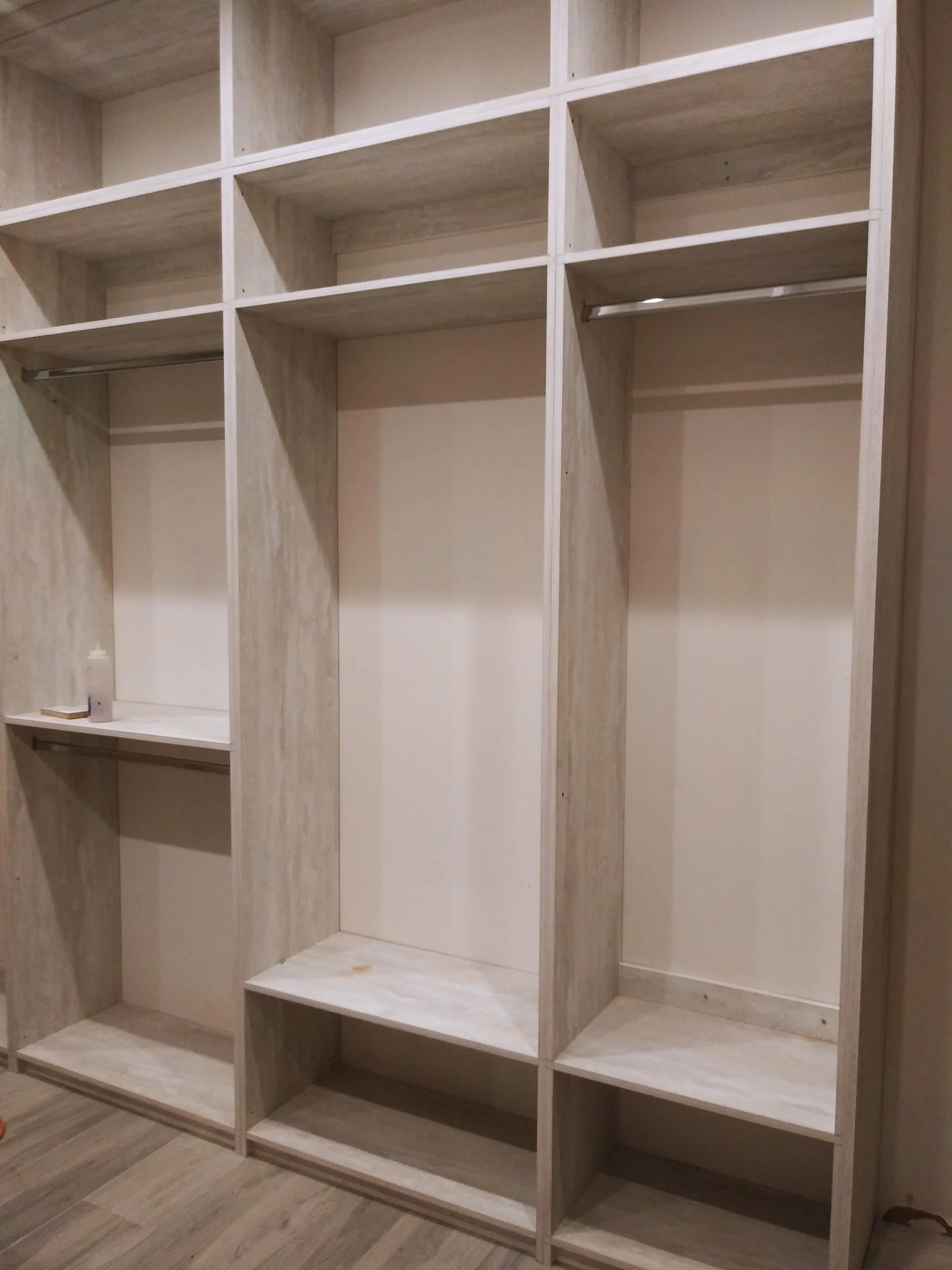 Custom gray closet with integrated storage