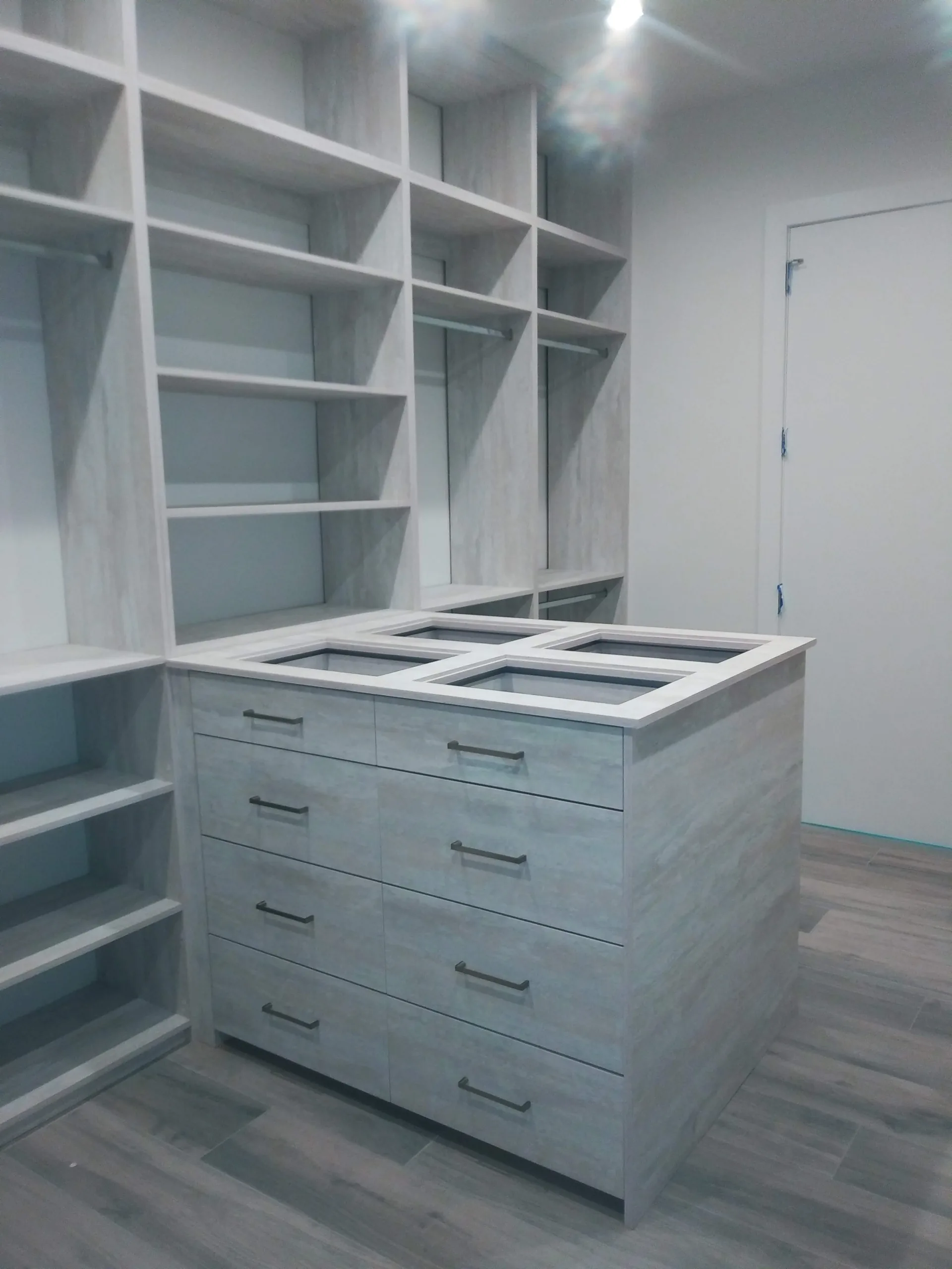 Custom gray closet with integrated storage