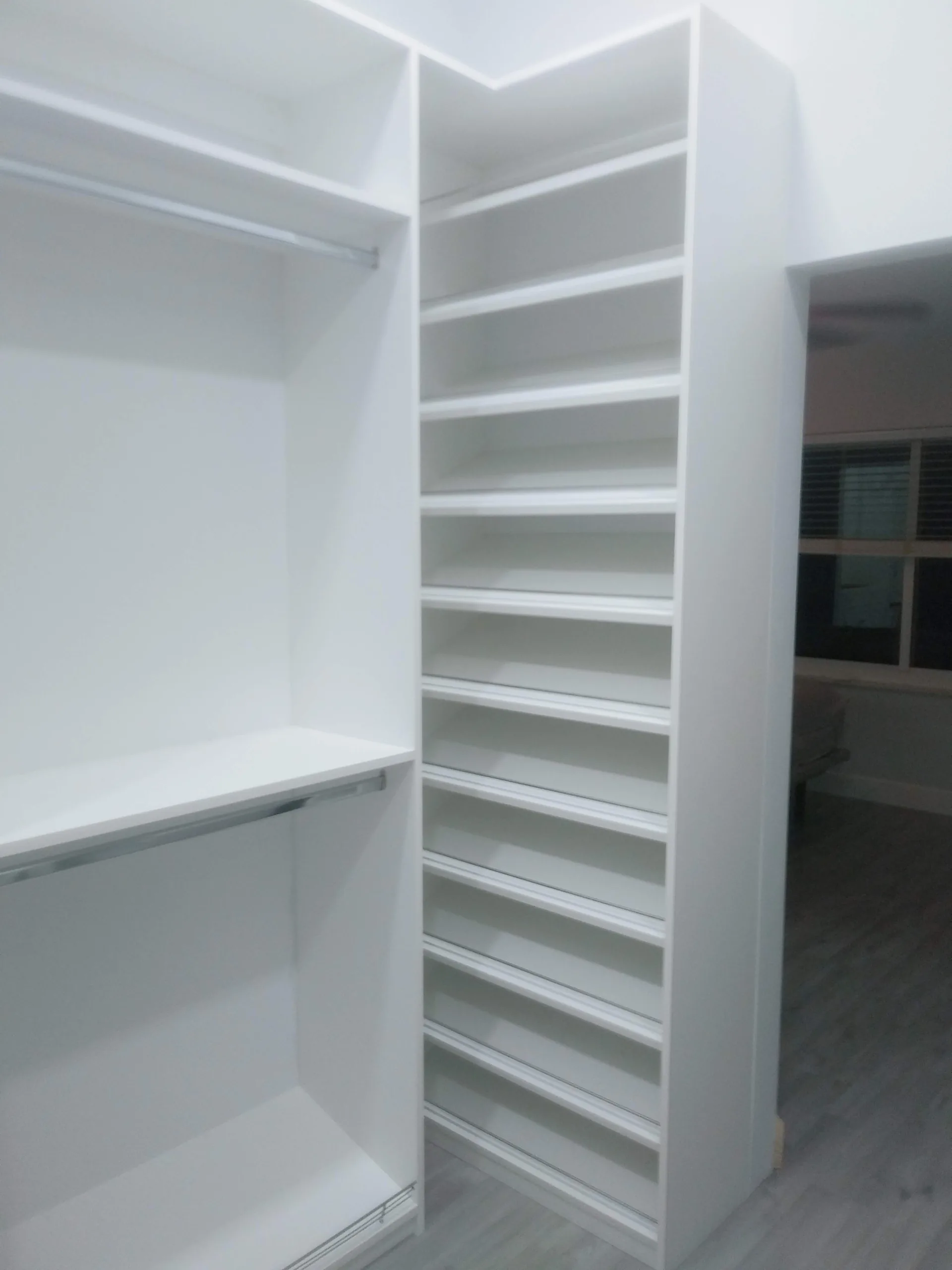 Custom white closet with shelving and hanging space