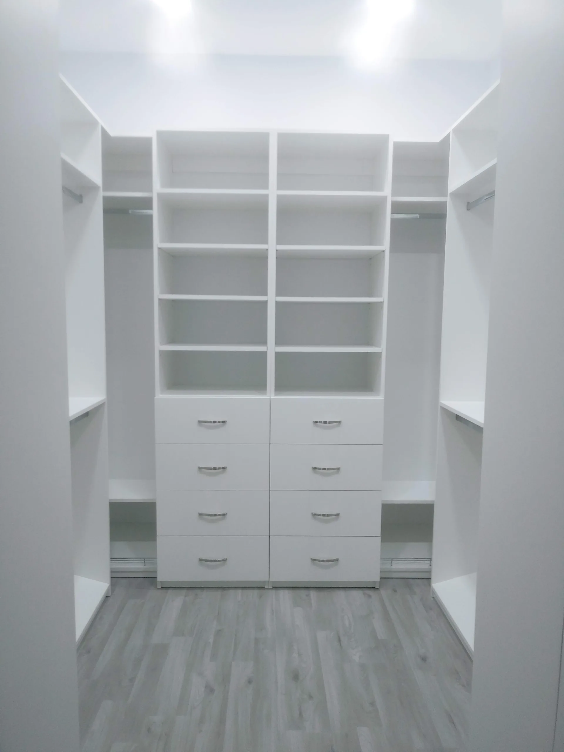 Custom white closet with shelving and hanging space