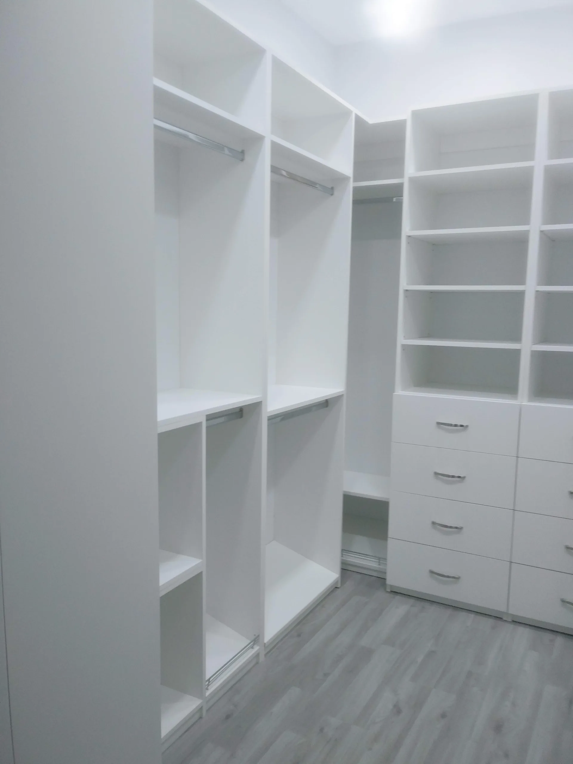 Custom white closet with shelving and hanging space