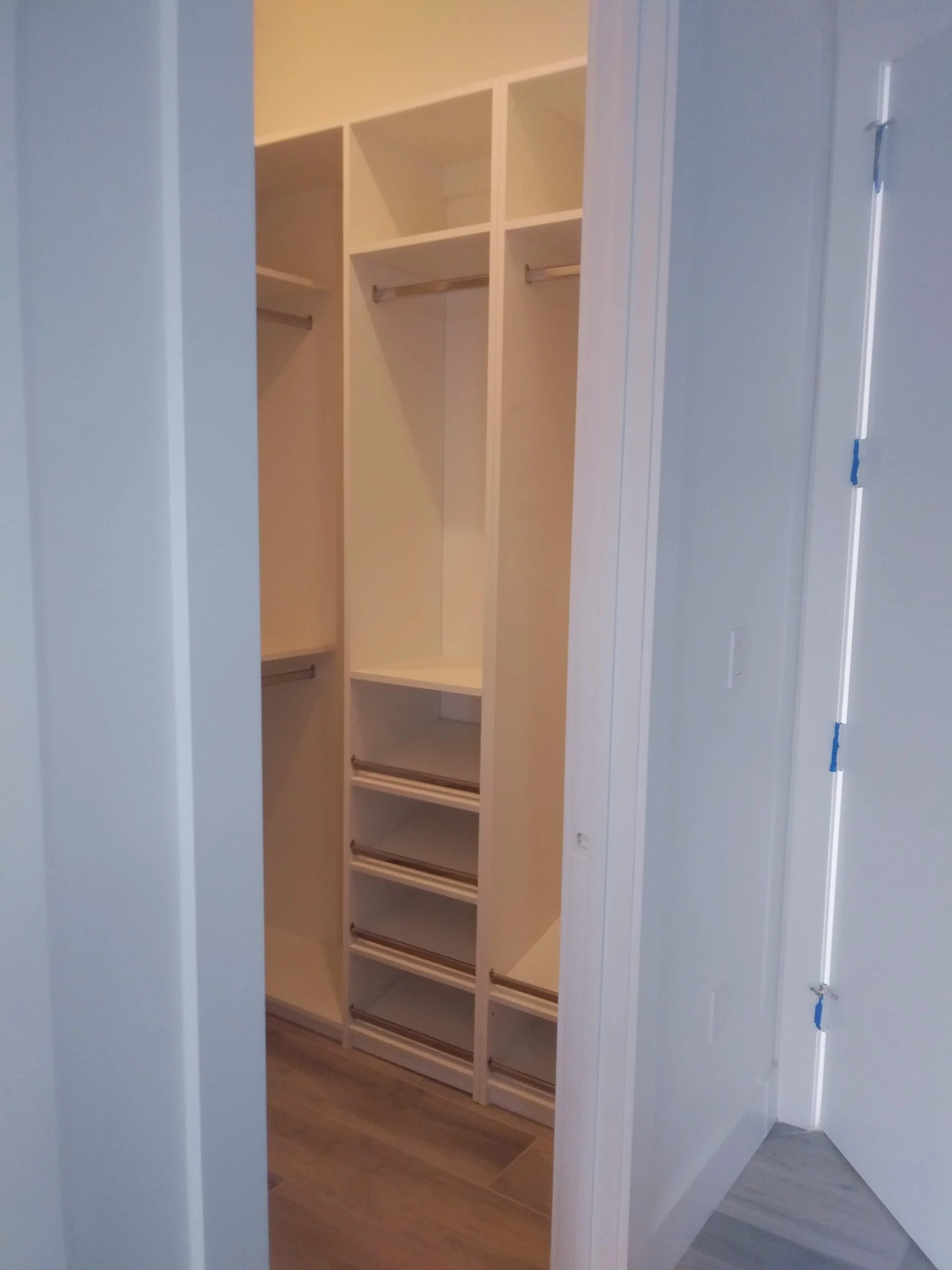 Custom white closet with shelving and hanging space
