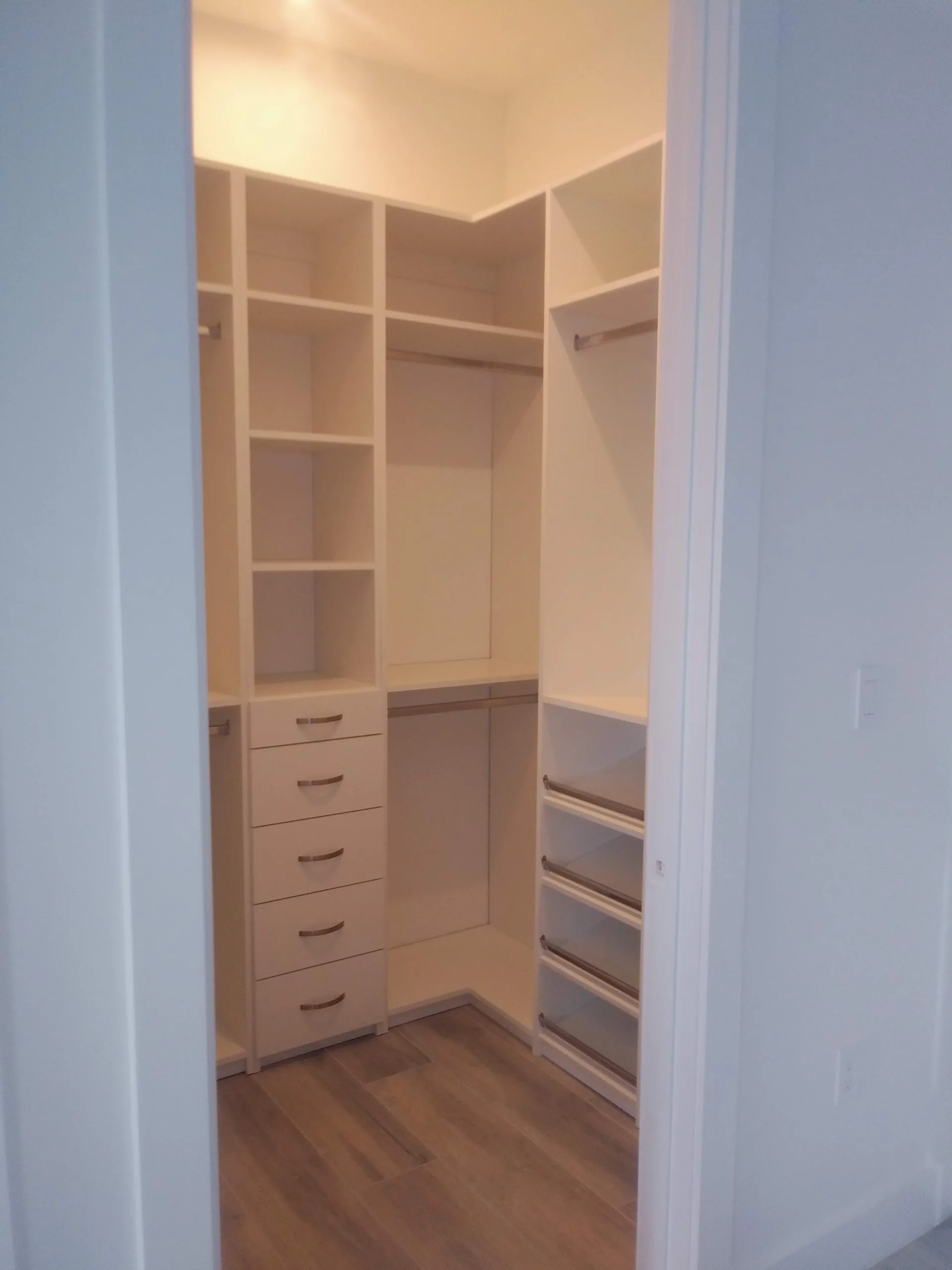 Custom white closet with shelving and hanging space