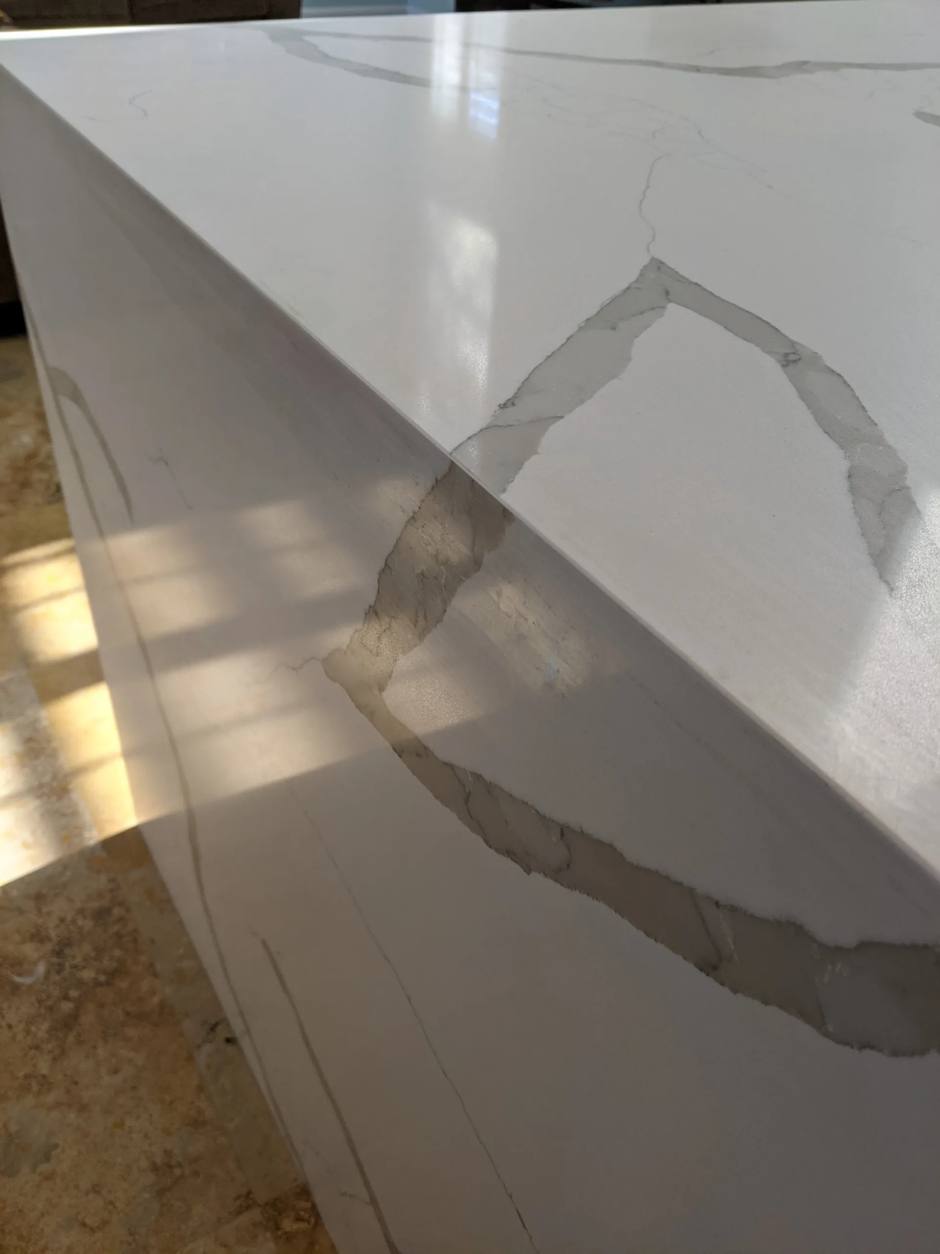 Detail of wood cabinetry and quartz countertop by Luciano