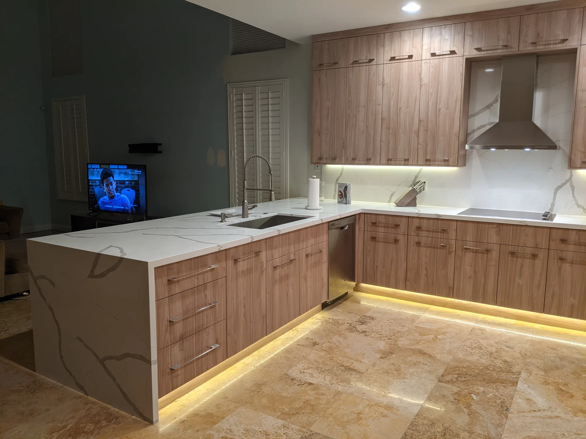 Wood kitchen cabinetry with a white quartz island
