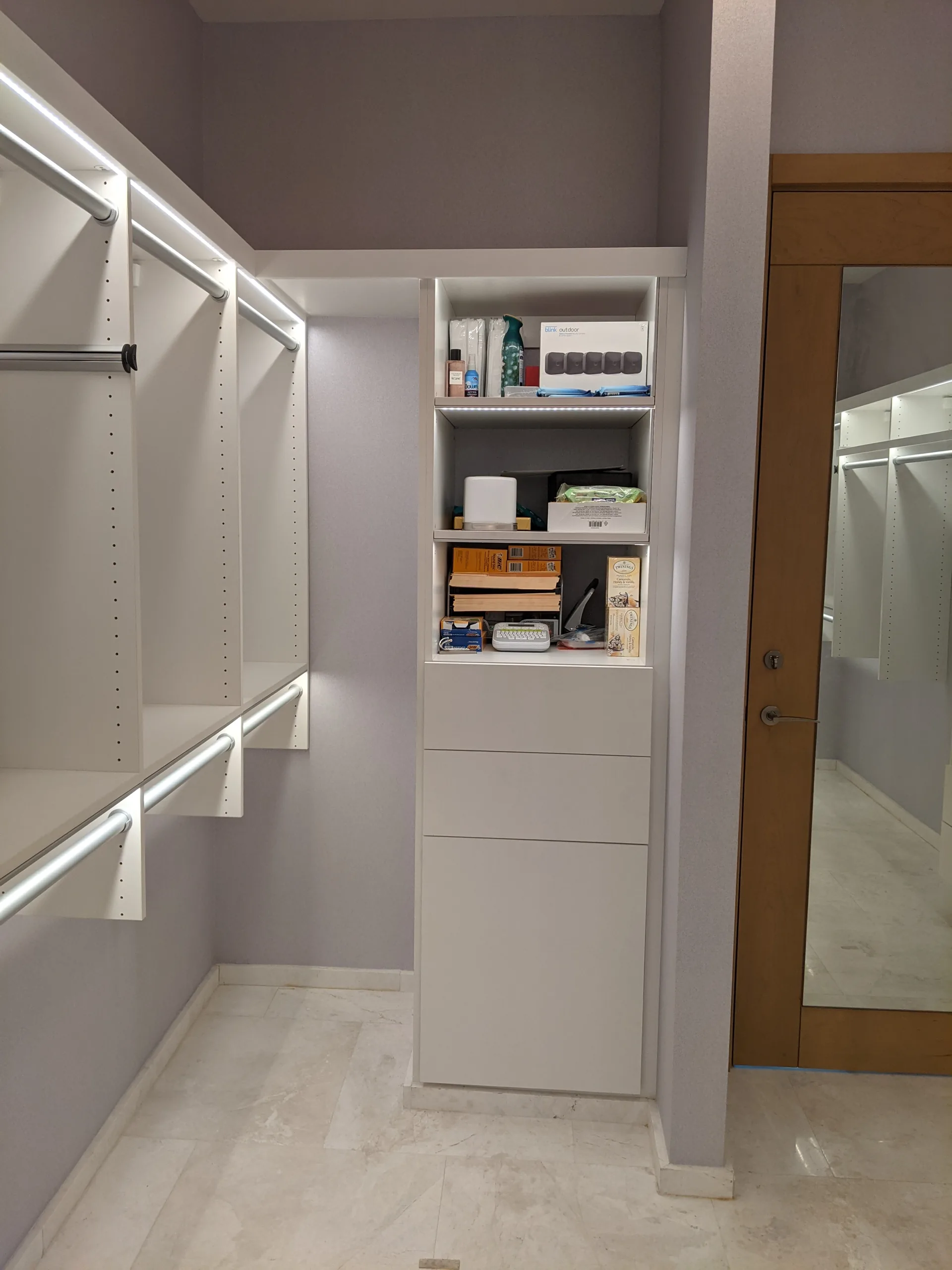 White closet with illuminated shelving