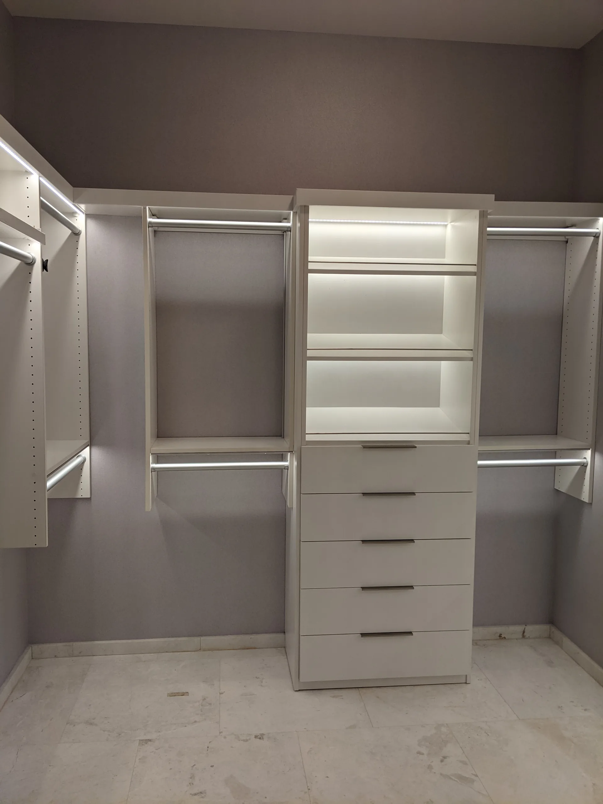 Custom walk-in closet with illuminated shelving