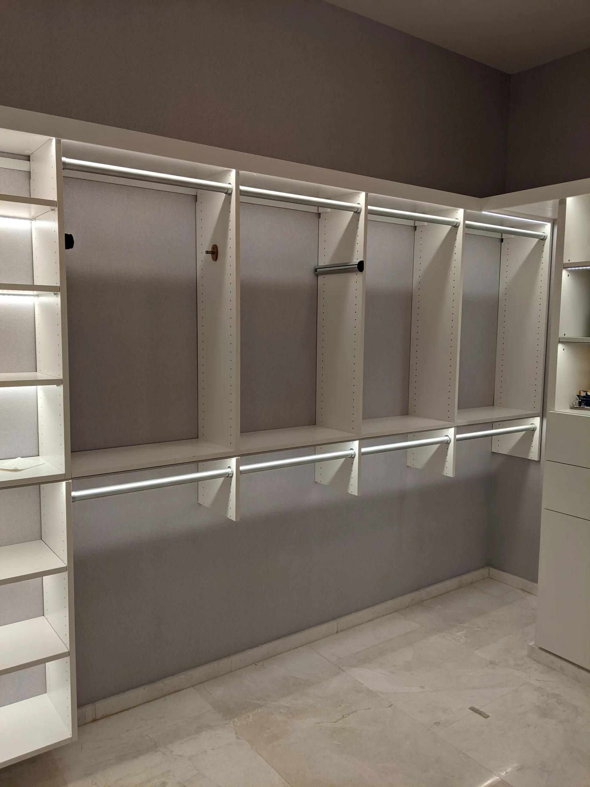 White closet with illuminated shelving
