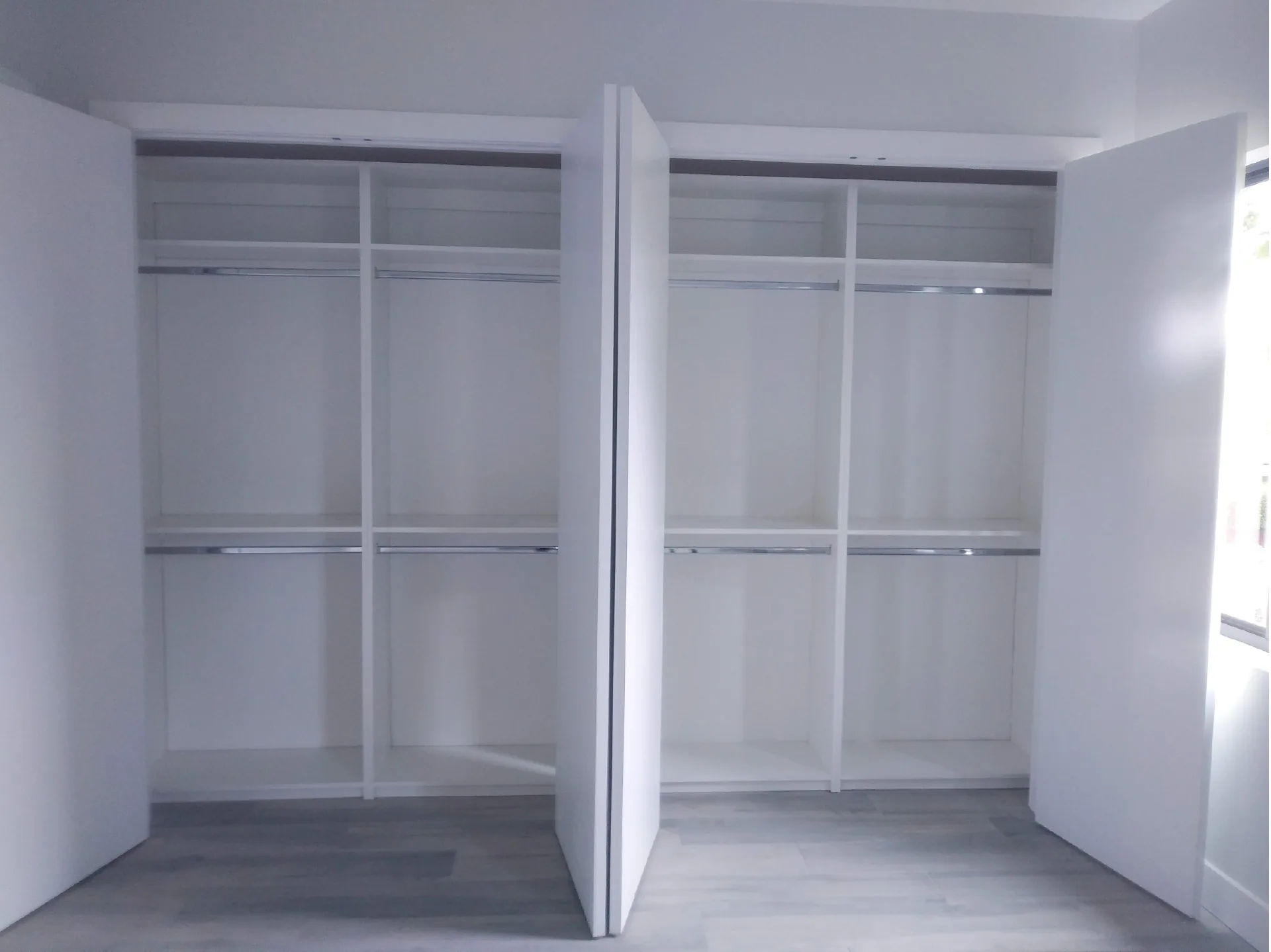 Custom white closet with shelving and hanging space