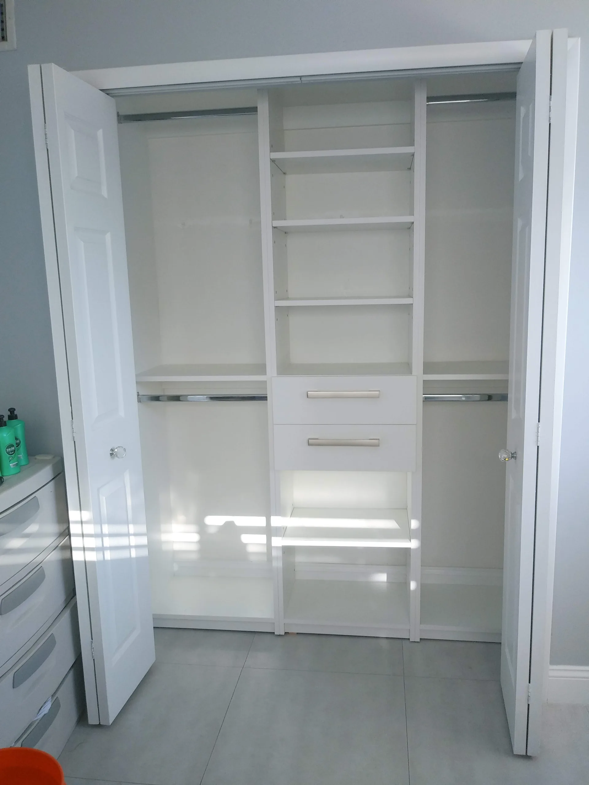 Custom white closet with shelving and hanging space
